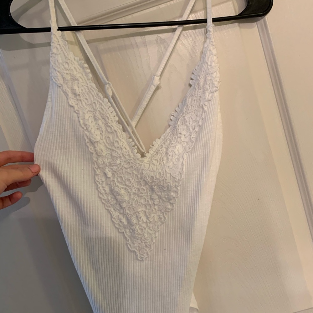 Cross back white body suit